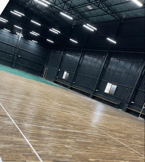 Wooden indoor court with badminton markings