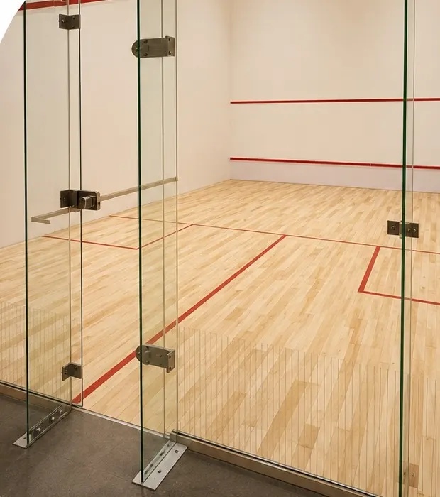 Squash court with a wooden floor and glass back wall
