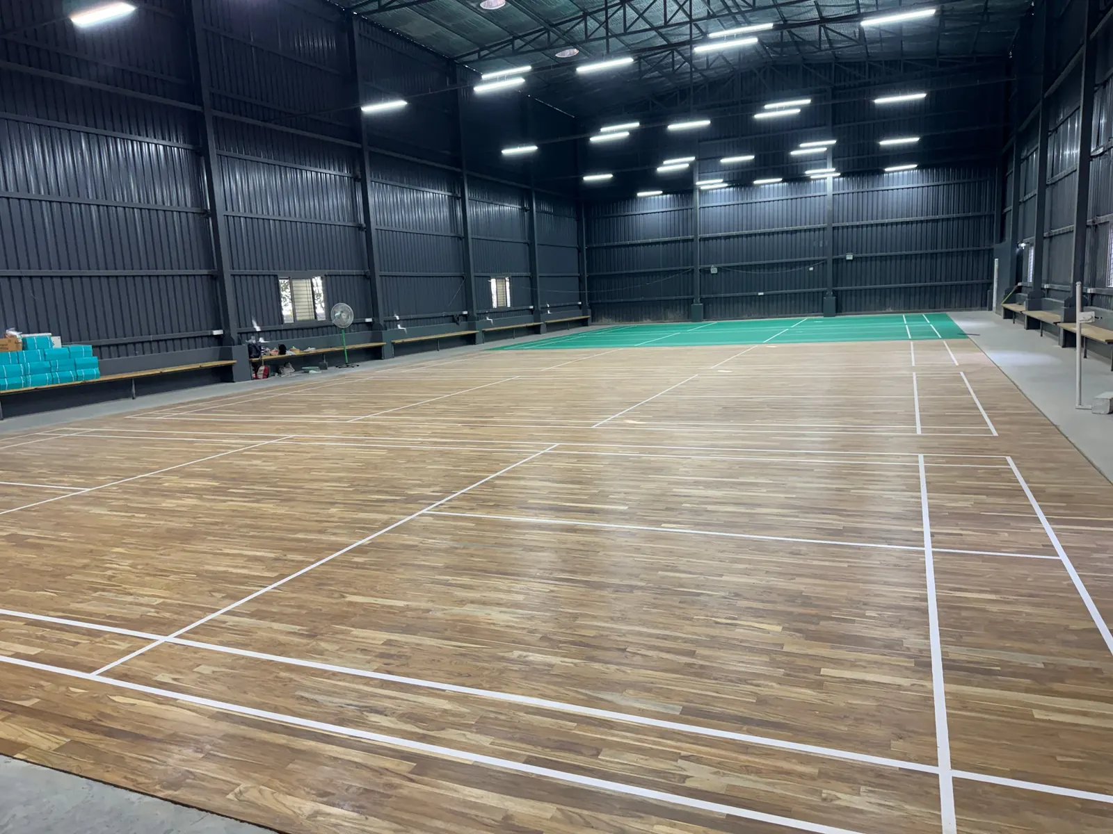 Wooden sports floor with white court markings in an indoor hall